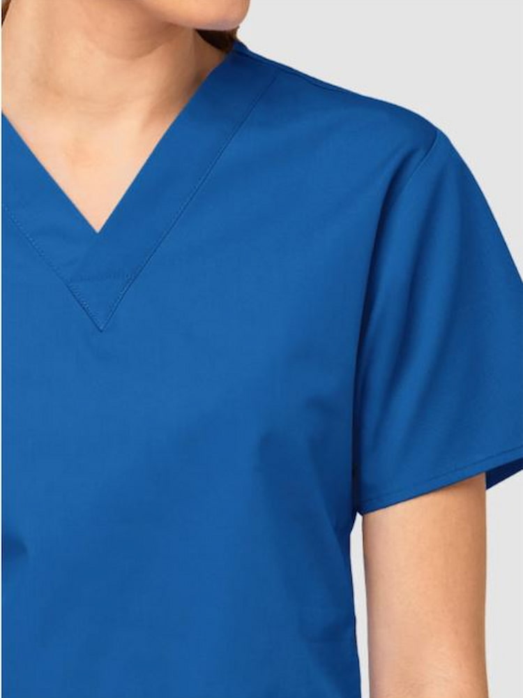 An up close image of the neckline of the WonderWink Origins Women's Bravo Scrub Top in Royal size Large featuring a modern fit.