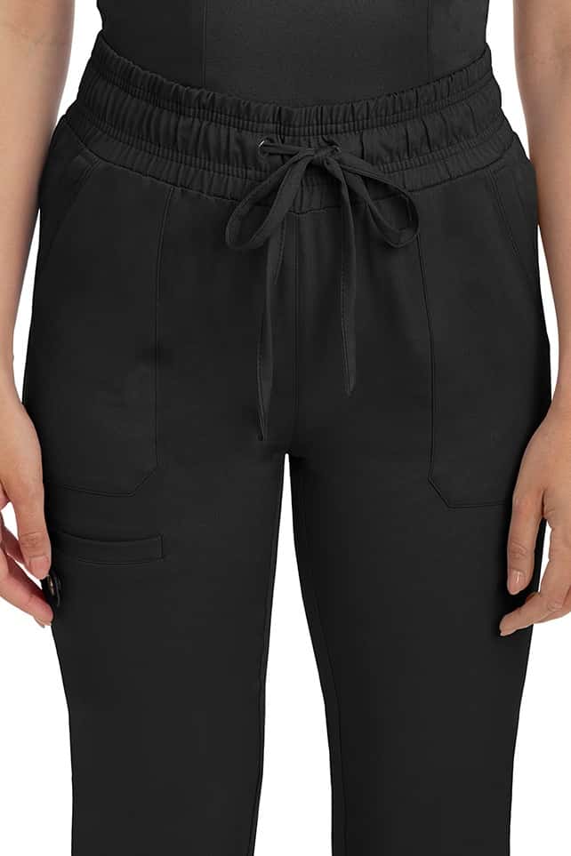 A female nurse wearing a Women's Renee Jogger Scrub Pant from HH Works in Black featuring a drawstring tie front.
