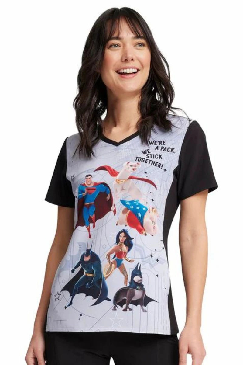 A young female children's nurse showcasing the front of the Super Pets Tooniforms Women's V-Neck Print Scrub Top.