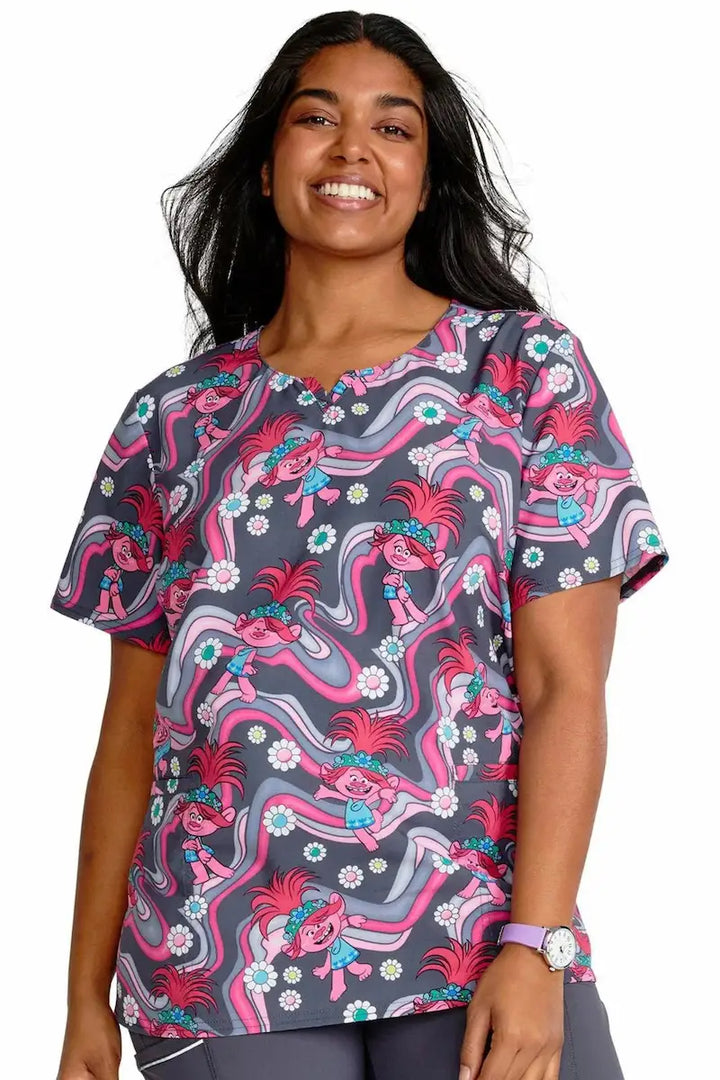 A young female Pediatric Nurse wearing a Tooniforms Women's V-Neck Print Top in Trollstopia featuring a contemporary fit.