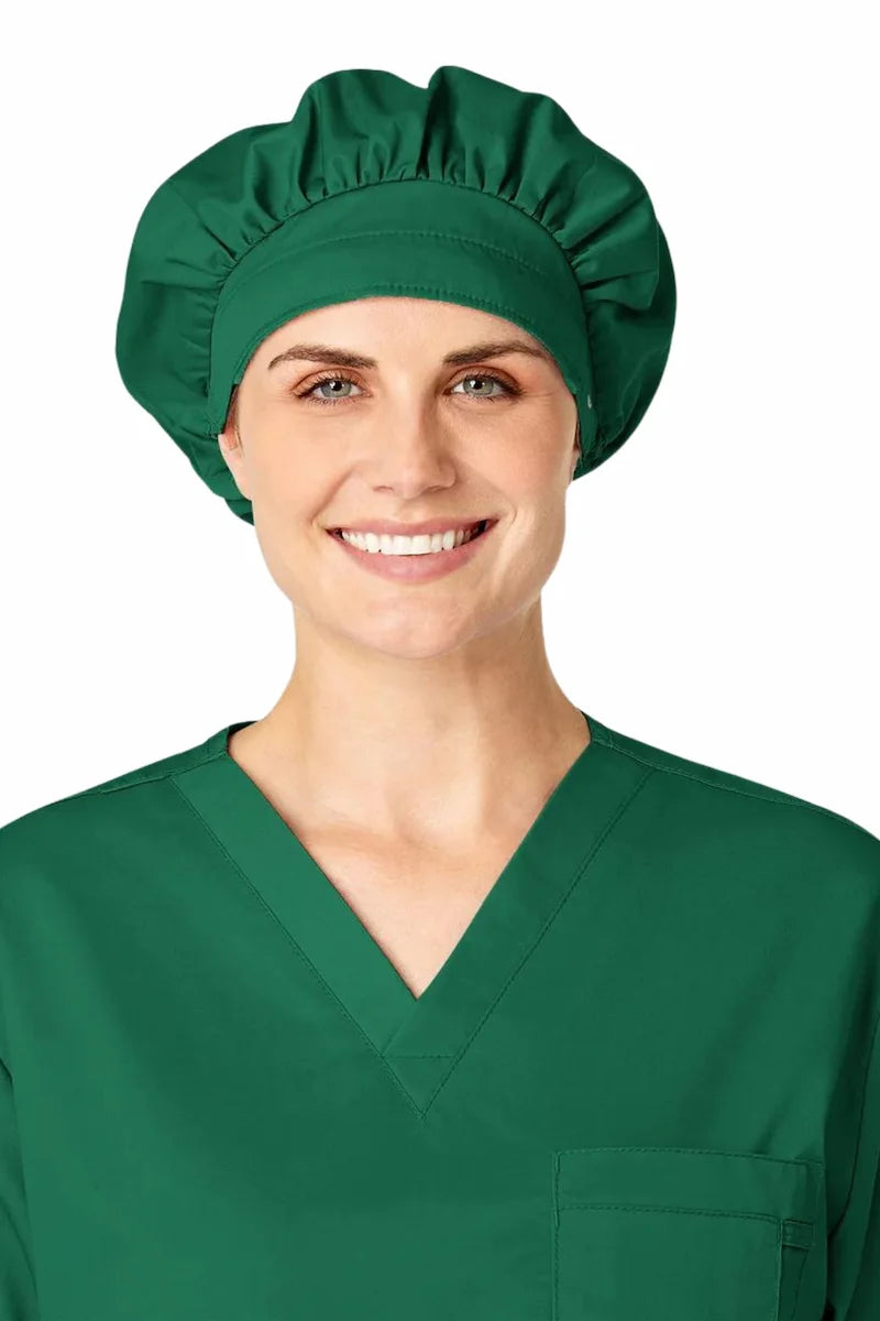 A young surgeon showcasing the WonderWink Women's Bouffant Scrub Cap in Hunter Green on a white background.