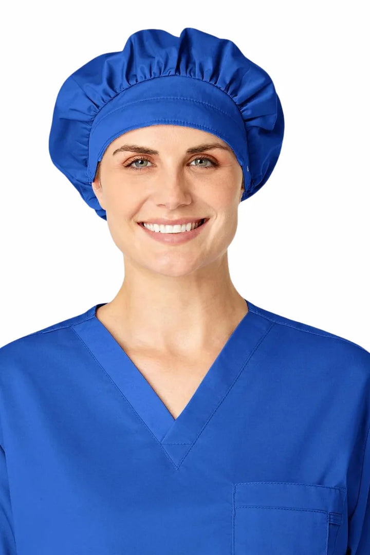 A young female showcasing the WonderWink Women's Bouffant Scrub Cap in Royal Blue featuring an adjustable stopper at the back for a secure fit. 