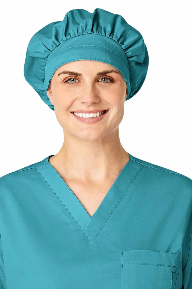 A young female Surgical Assistant displaying the WonderWink Women's Bouffant Scrub Cap in Teal Blue.