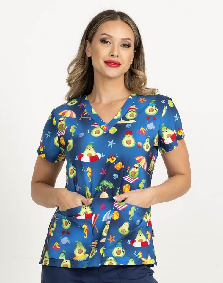 A young female Medical Assistant wearing a Meraki Sport Women's Print Scrub Top in "Avocado Paradise" size Medium featuring a v-neckline & short sleeves.