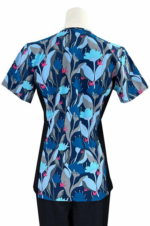 An Essentials Women's Mock Wrap Side Panels Scrub Top in "Midnight Poppies" featuring 2 front patch pockets & 1 exterior utility pocket on the wearer's right side.