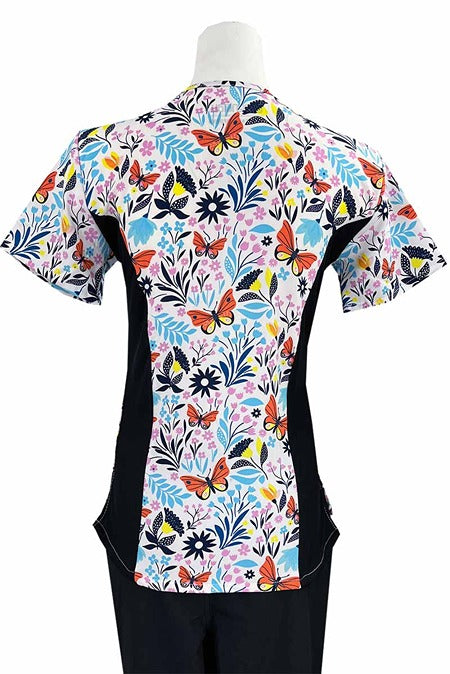 An Essentials Women's Zip Neck Scrub Top in "Butterfly Garden" featuring 2 front patch pockets for all of you on the go storage needs.