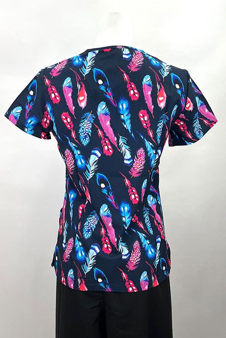 An image of the Revel Women's V-neck Print Scrub Top in "Fancy Feathers" size Small featuring side slits for additional range of motion throughout the day.