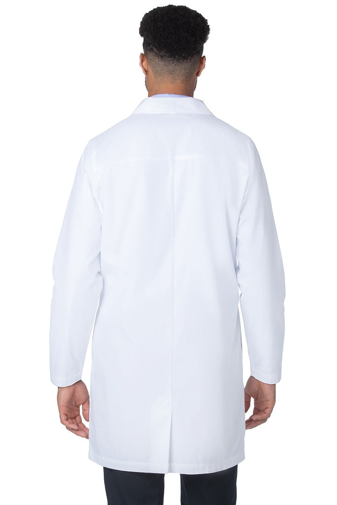 A young male Medical Practitioner wearing a Landau Unisex 4-Pocket Mid-Length Lab Coat in White Sanded size Medium featuring a length of 37.75",