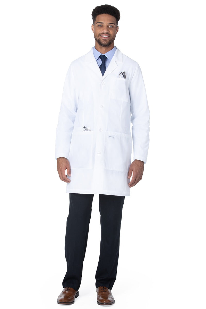 A male Pharmacist wearing a Landau Unisex 4-Pocket Mid-Length Lab Coat in White Sanded featuring  twice the yarn for durability.