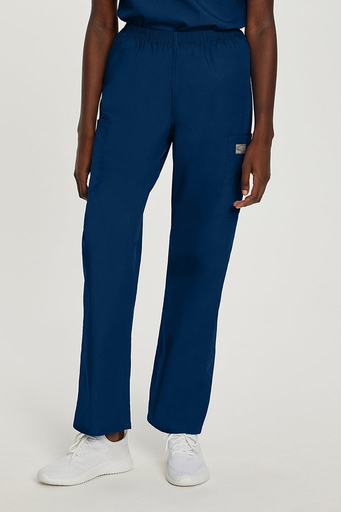 A young female Medical Sonographer wearing a Landau ScrubZone Women's Elastic Waist Cargo Pant in True navy size Medium Petite featuring a classic relaxed fit that is generously cut for optimal comfort & ease of movement.