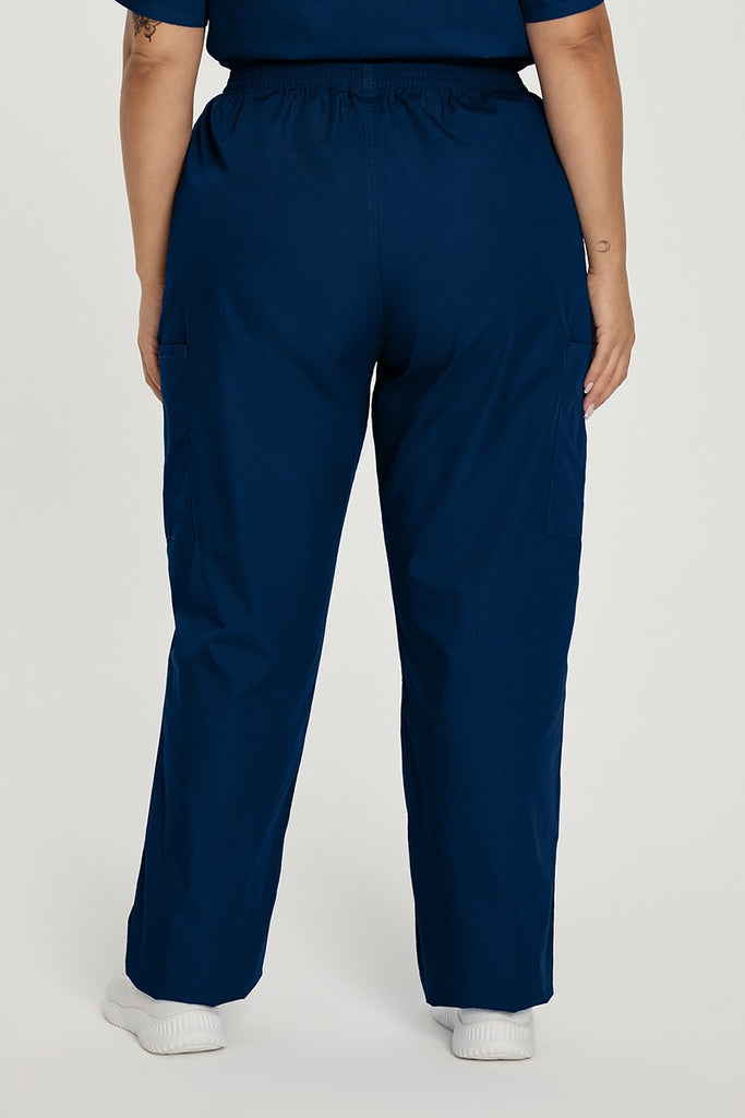 A young female RN wearing a pair of the Landau ScrubZone Women's Elastic Waist Cargo Pants in True Navy size 2XL petite featuring a breathable fabric for easy care and a more comfortable fit.