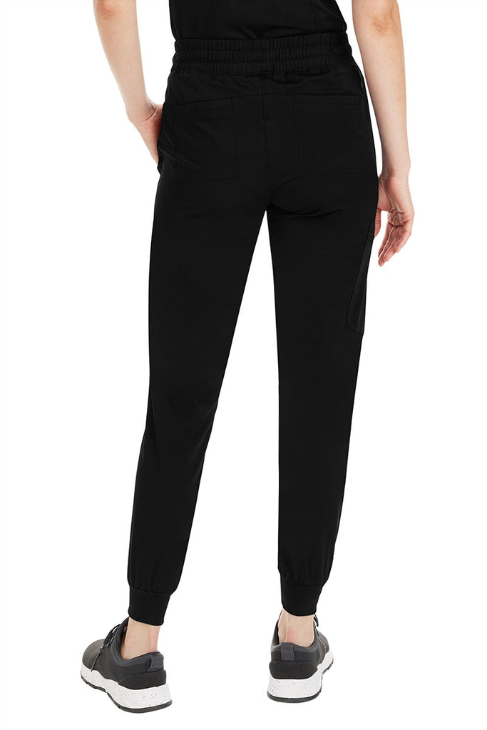 A young female Pharmacy Technician wearing a Purple Label by Healing Hands Women's Aspen Jogger Scrub Pant in "Black" size XS Petite featuring 2 back patch pockets.