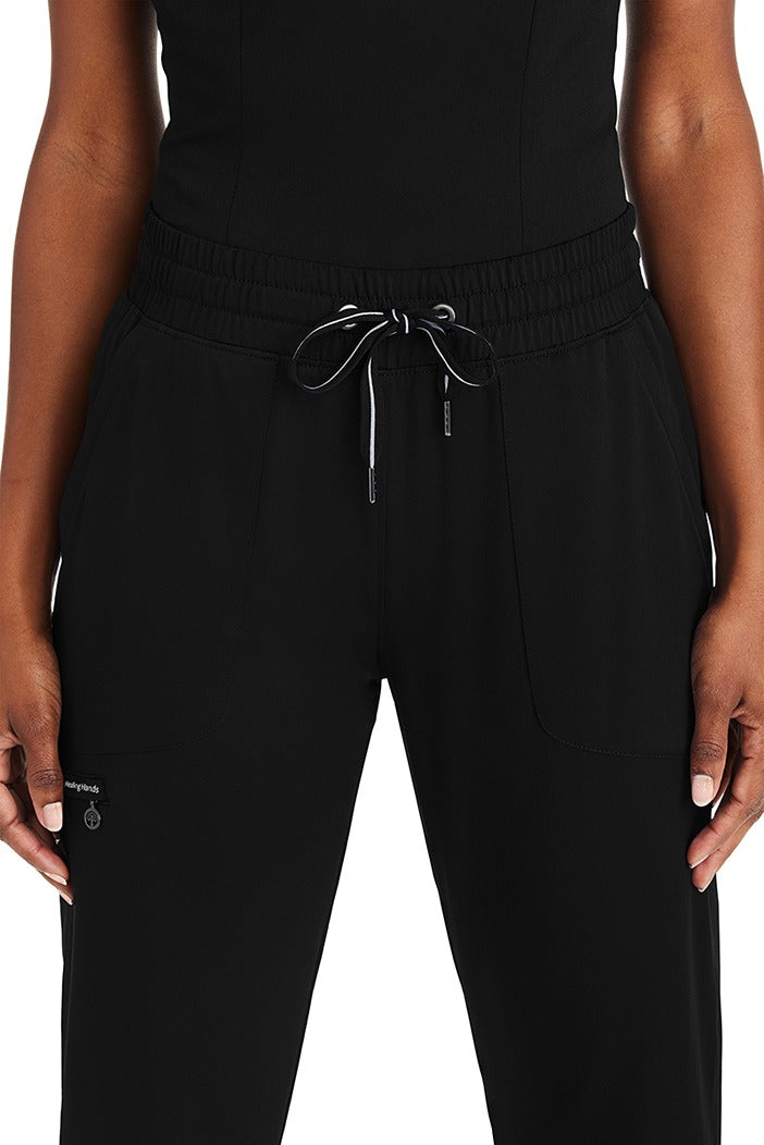A female Registered Nurse wearing a Purple Label Women's Knit Lined Alaskan Pant in "Black" size Small Petite featuring an elastic waist with a comfort drawstring.