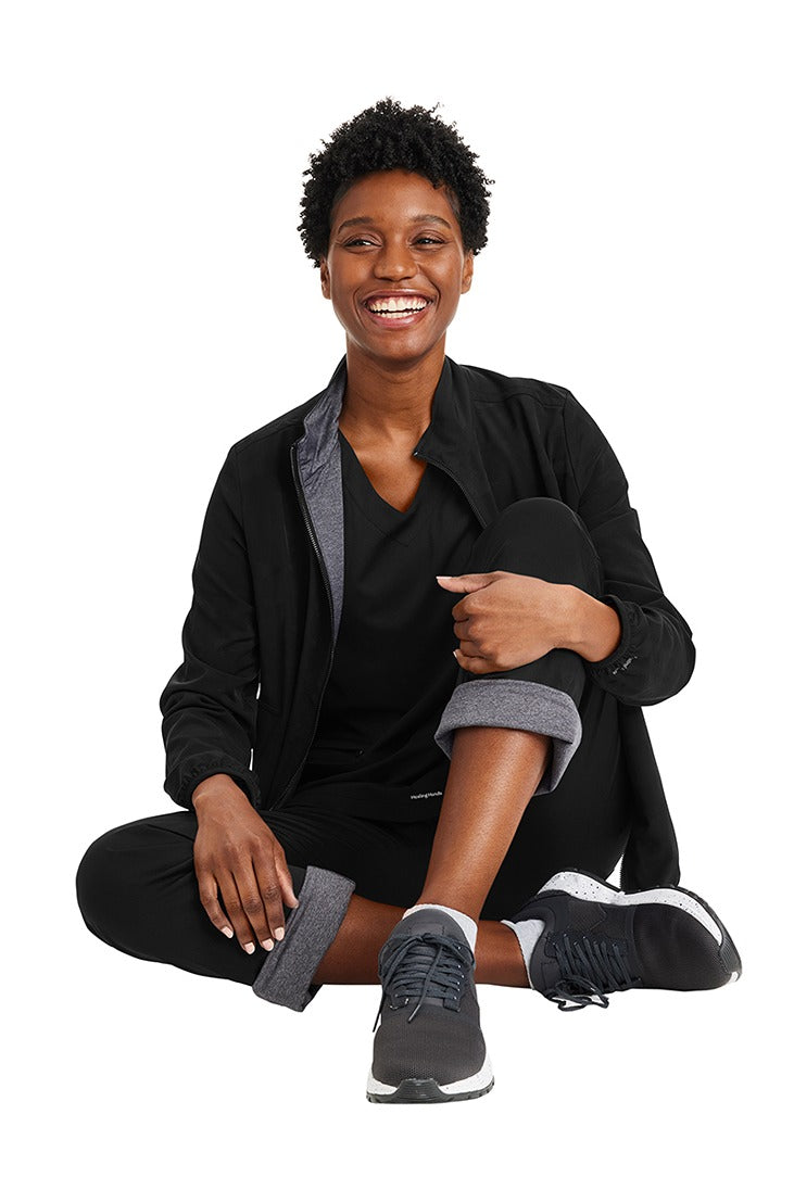 A young female Phlebotomist wearing a Purple Label Women's Knit Lined Alaskan Pant in "Black" size Small Petite featuring a soft knit lining throughout.