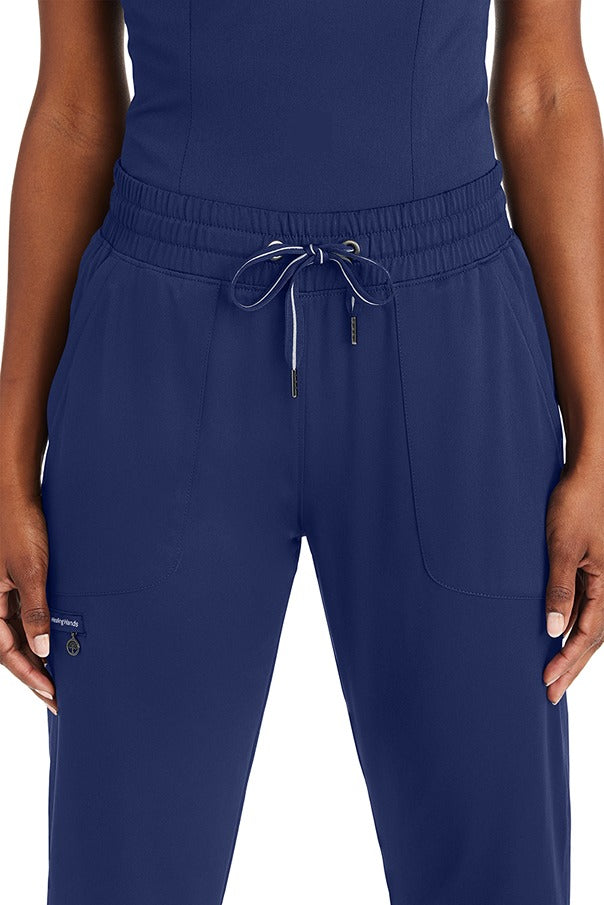 A female Registered Nurse wearing a Purple Label Women's Knit Lined Alaskan Pant in "Navy" size Large Petite featuring an elastic waist with a comfort drawstring.