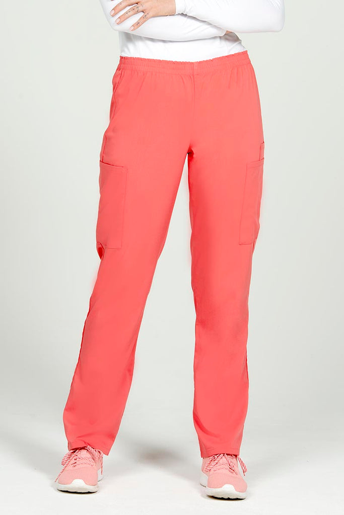 A female Nursing Assistant wearing an Epic by MedWorks Women's Elastic Waist Scrub Pant in Coral size Large featuring a natural rise, classic fit.