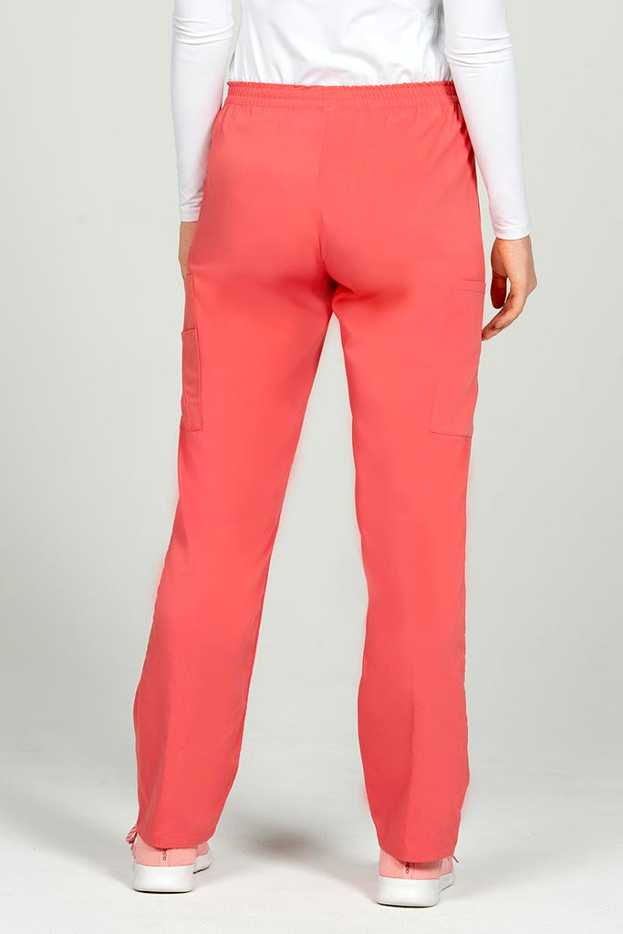 A female RN wearing an Epic by MedWorks Women's Elastic Waist Scrub Pant in Coral size Medium featuring a tapered leg.