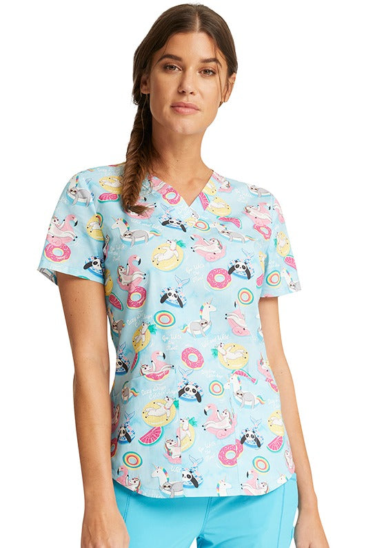 A young woman wearing a Women's V-Neck Print Scrub Top from Cherokee Uniforms in "Go With The Float".