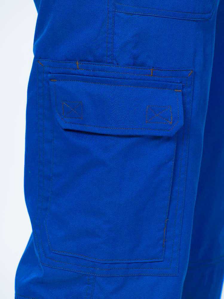 Man wearing an Epic by MedWorks Men's Button Front Scrub Pant in royal with 1 double cargo pocket on wearer's right side.