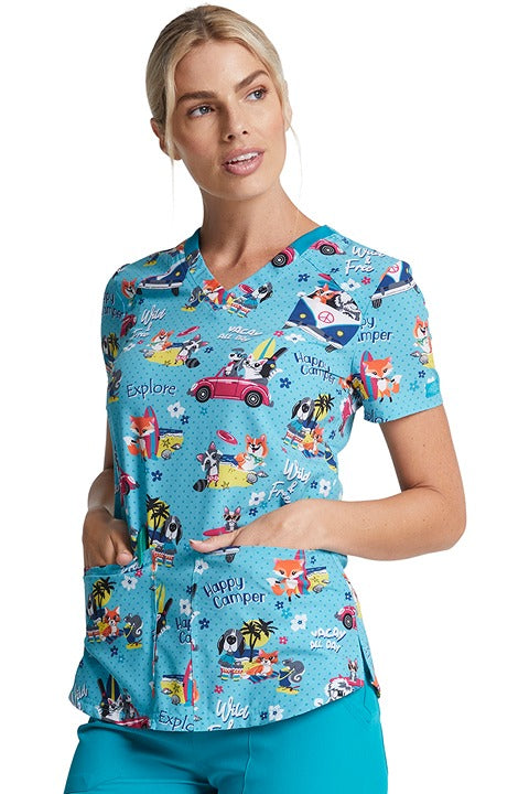 A young female LPN wearing a Dickies Women's V-neck Print Scrub Top in "Vacay All Day" featuring a v-neckline.