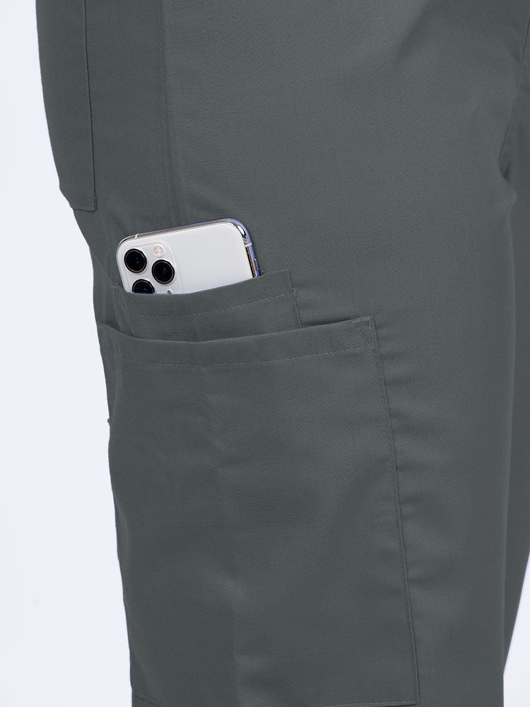 Female nurse wearing a Luv Scrubs Unisex Drawstring Cargo Pant in pewter with 1 cargo & cell phone pocket on the wearer's right side.