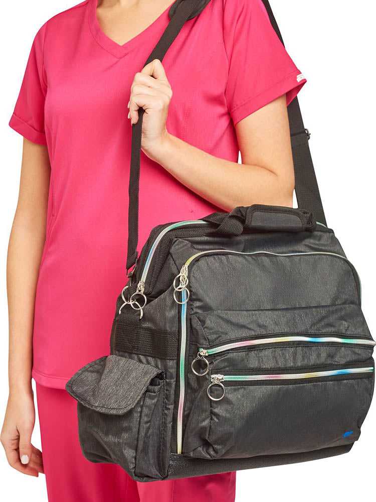 A young female CNA carrying the Nurse Mates Ultimate Medical Bag in "Charcoal\Rainbow" featuring a hardwearing shoulder strap.