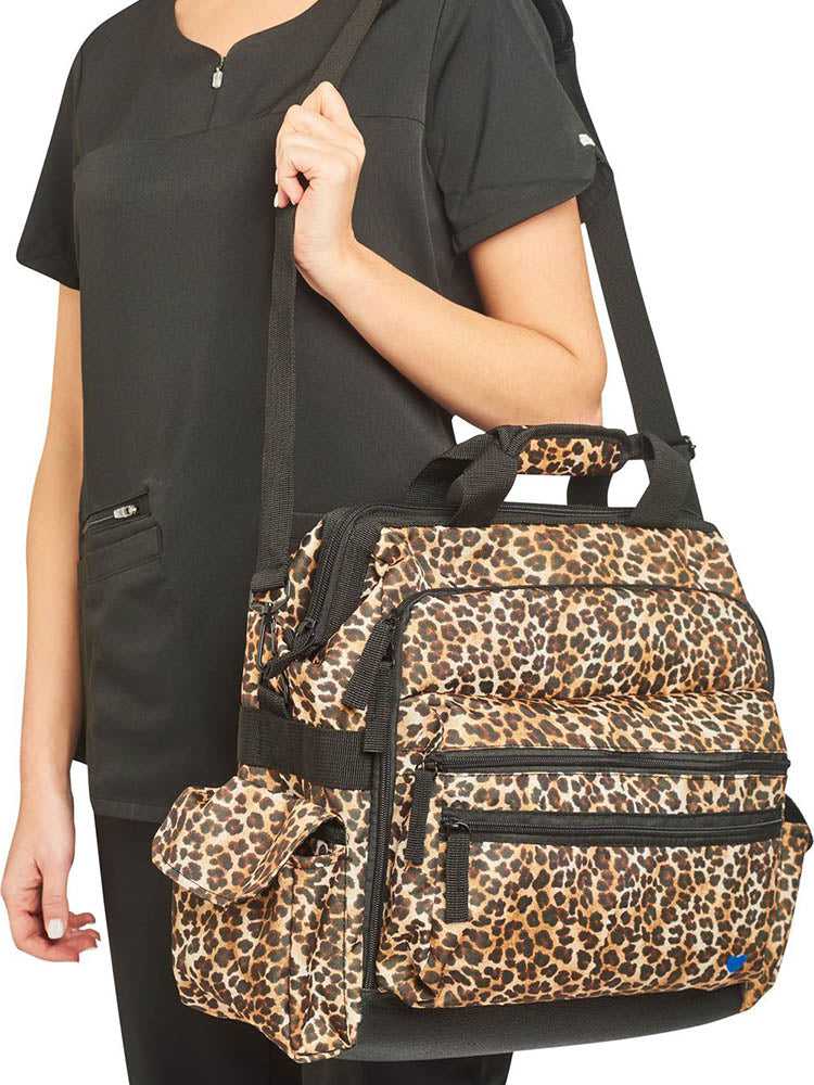 A young female CNA carrying the Nurse Mates Ultimate Medical Bag in "Cheetah Print" featuring a hardwearing shoulder strap.