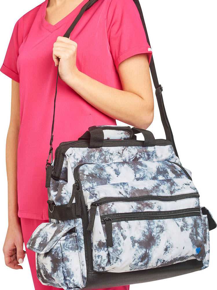 A young female LPN carrying a Nurse Mates Ultimate Medical Bag in "Black & White Tie Dye" featuring an adjustable nylon strap.