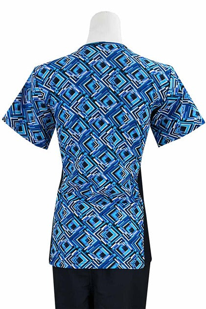 An Essentials Women's Mock Wrap Side Panels Scrub Top in "Royal Prisms" featuring 2 front patch pockets & 1 exterior utility pocket on the wearer's right side.
