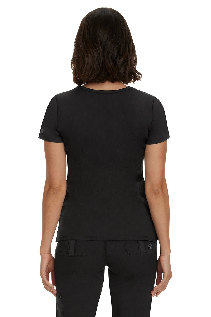 A female CNA wearing a Purple Label Women's Juliet Yoga Scrub Top in Black featuring a medium center back length of 24".