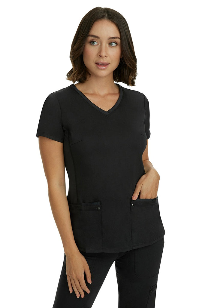 A lady nurse wearing a Purple Label Women's Juliet Yoga Scrub Top in Black featuring a super comfortable stretch fabric made of 77% polyester/20% rayon/3% spandex.