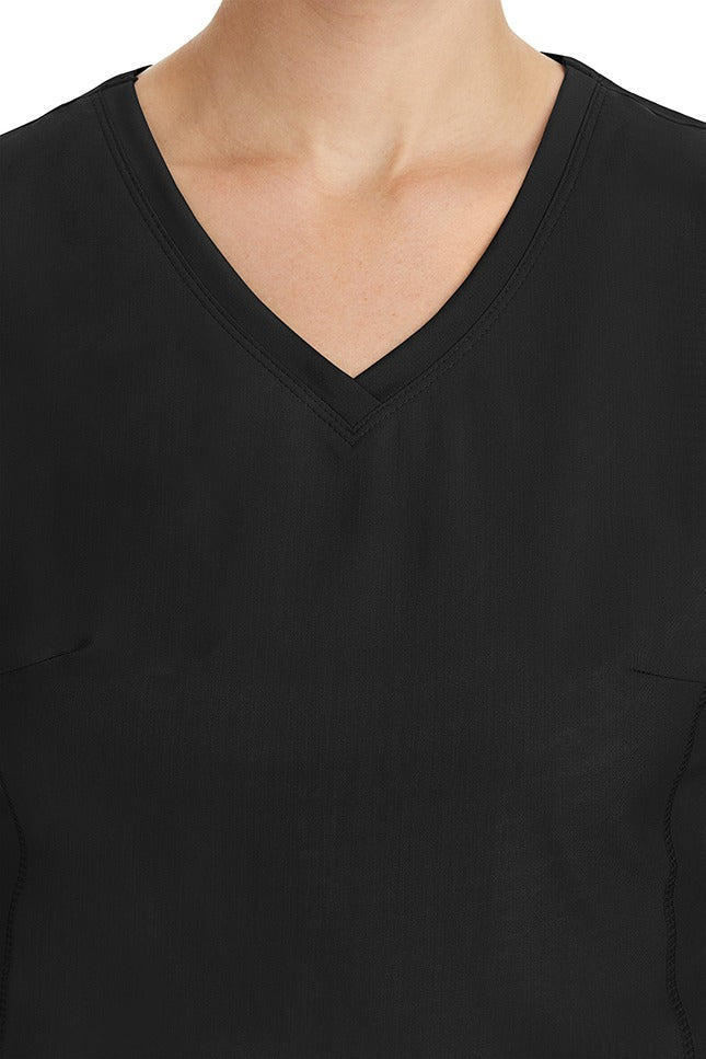 A young healthcare professional wearing a Purple Label Women's Juliet Yoga Scrub Top in Black featuring a modern fit.