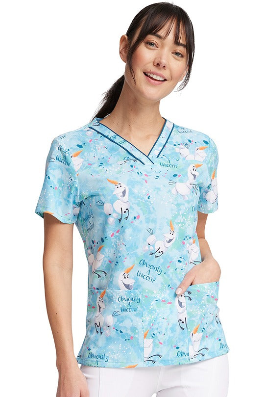 A female Registered Nurse wearing a Tooniforms Women's V-Neck Print Scrub Top in "Obviously a Unicorn" featuring a stylized V-neckline & short sleeves.