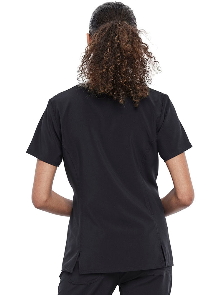 A young female LPN wearing a Women's V-neck Print Scrub Top from Cherokee Tooniforms featuring a medium center back length of 25.5".