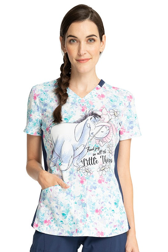 A young female LPN wearing a Women's V-Neck Print Top from Cherokee Tooniforms in "Find Joy".
