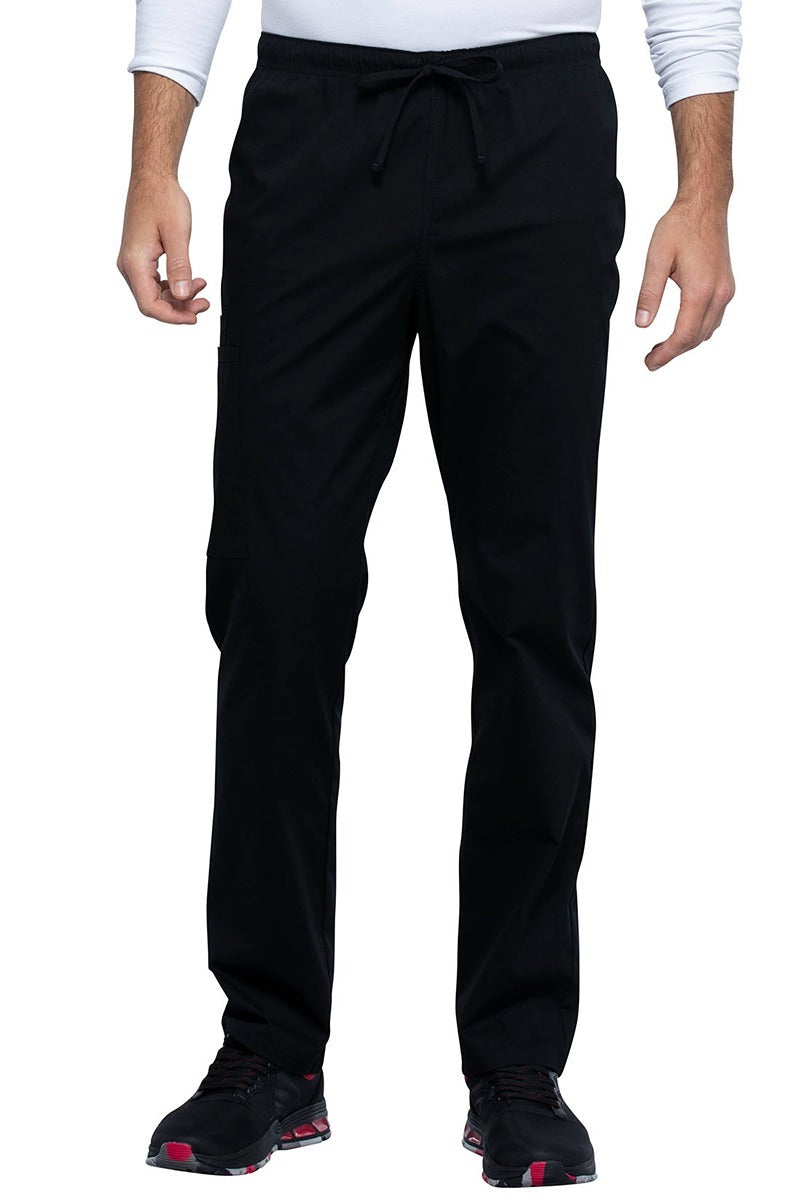 A picture of a male Nurse Practitioner wearing a Cherokee Unisex Straight Leg Scrub Pant in Black size XL Tall featuring a Bi-Stretch, durable fabric.