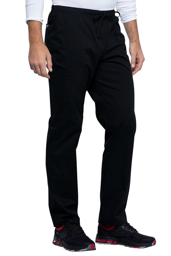 An image of the side of the Cherokee Unisex Straight Leg Drawstring Scrub Pant in Black size 2XL Tall featuring the signature Cherokee Woven Label on the wearer's back left patch pocket.