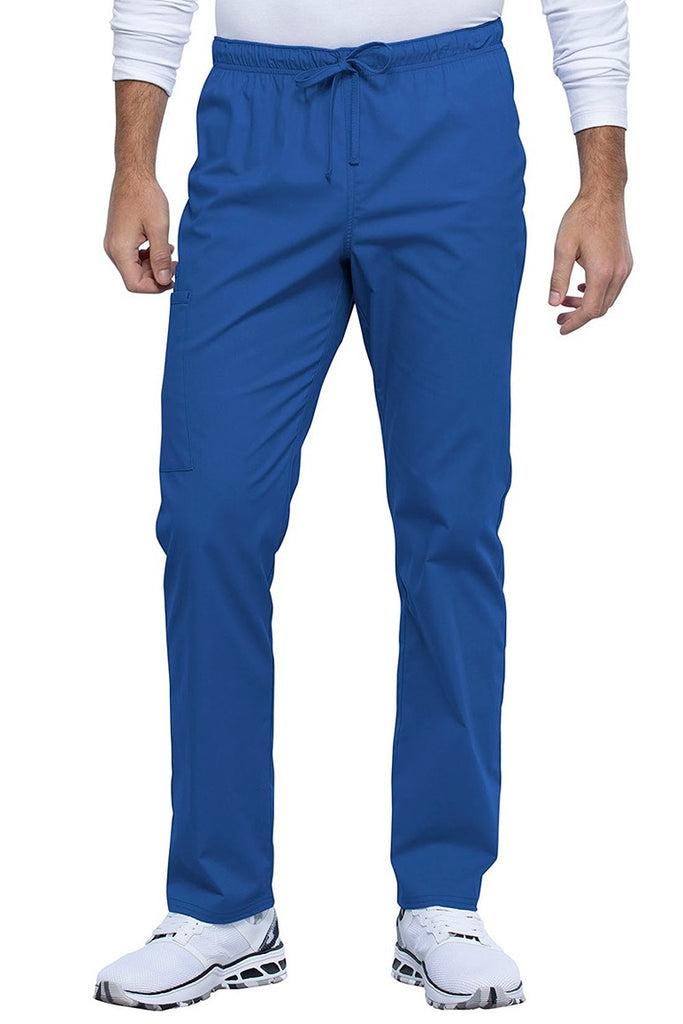 A picture of a male Nurse Practitioner wearing a Cherokee Unisex Straight Leg Scrub Pant in Royal size XL Tall featuring a Bi-Stretch, durable fabric.