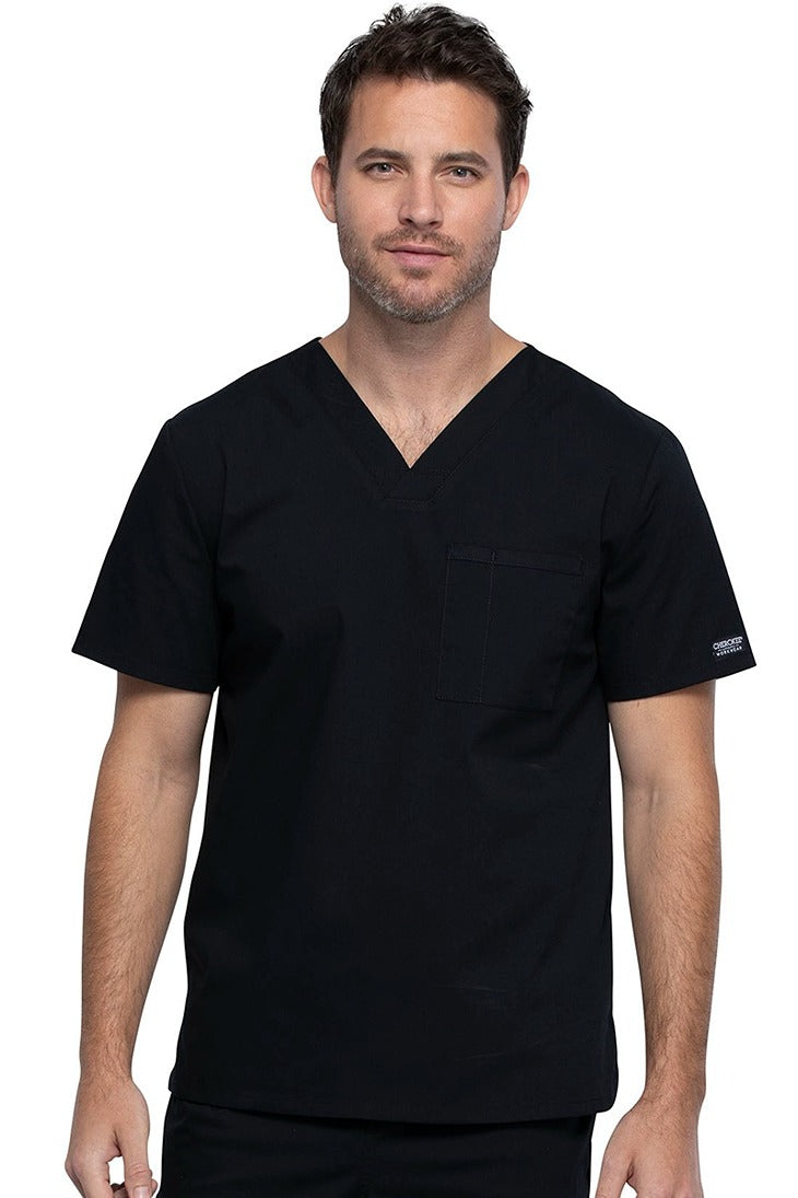 A middle aged Male Physician wearing a Cherokee Unisex Tuck-in V-neck Scrub Top in Black size XL featuring 1 front chest pocket.