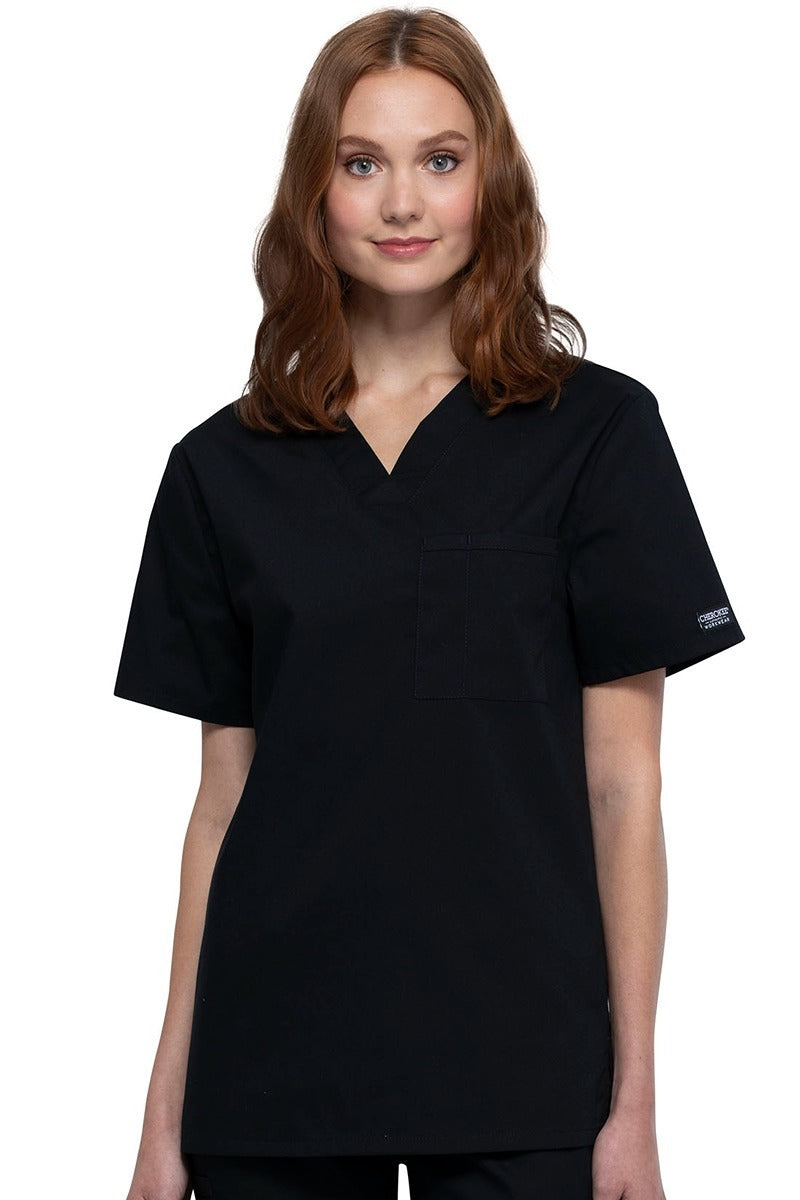 A female Nursing Assistant wearing a Cherokee Unisex Tuckable V-neck Scrub Top in Black size Small featuring a unique Poly/Cotton/Spandex blend fabric.