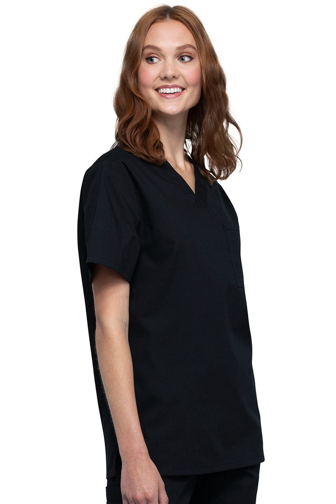 A young female Nurse Practitioner wearing a Cherokee Unisex Tuck-in V-neck Scrub Top in Black size Large featuring short sleeves & a V-neckline.