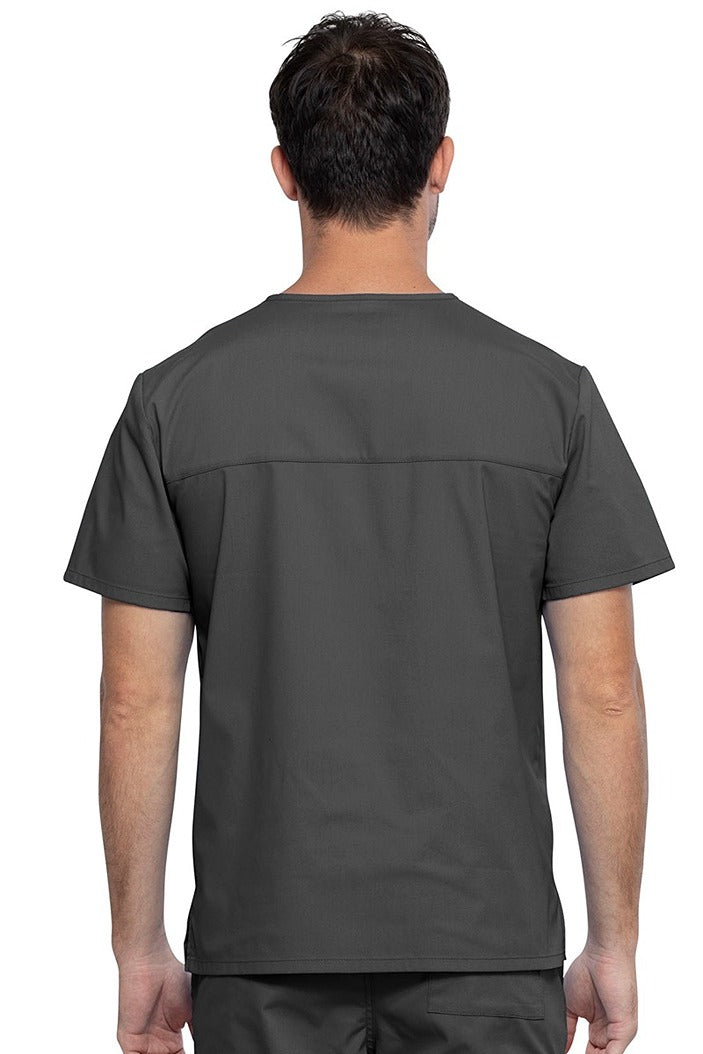 An image of a Male Medical Assistant wearing a Cherokee Unisex Tuckable V-neck Scrub Top in Pewter size 3XL featuring a back yoke & dolman sleeves.
