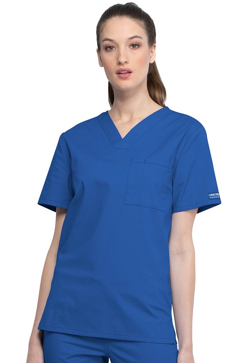 A female Nursing Assistant wearing a Cherokee Unisex Tuckable V-neck Scrub Top in Royal size Small featuring a unique Poly/Cotton/Spandex blend fabric.