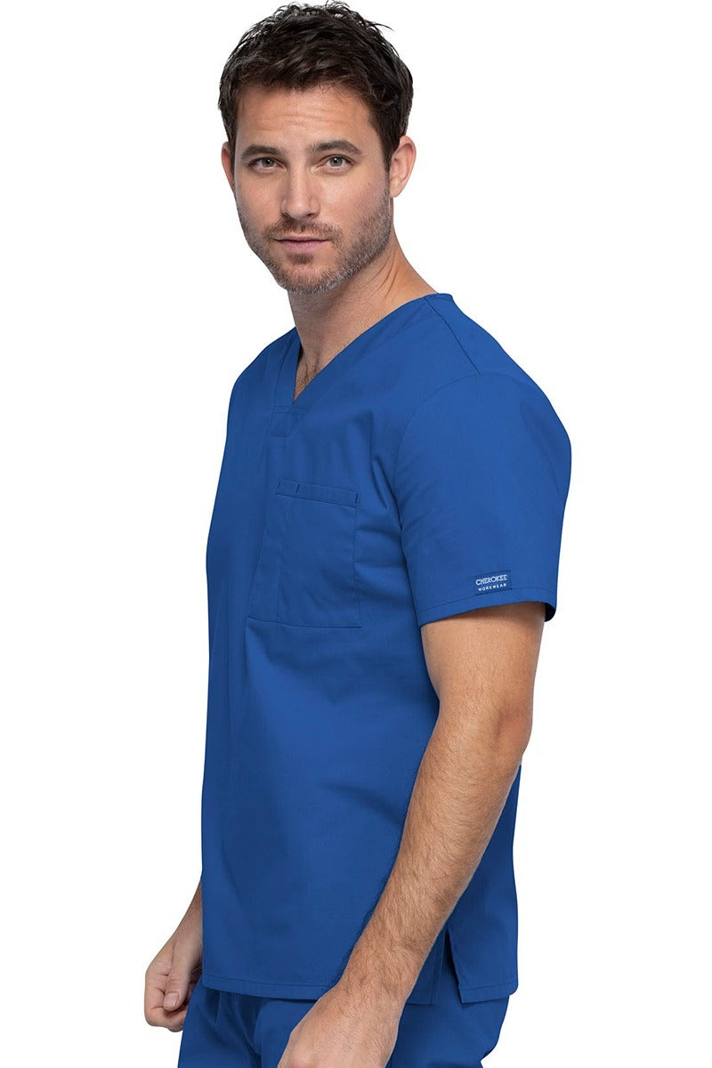 A picture of a young Male Phlebotomist wearing a Cherokee Unisex Tuckable V-neck Scrub Top in Royal size Large featuring pull-on closure.