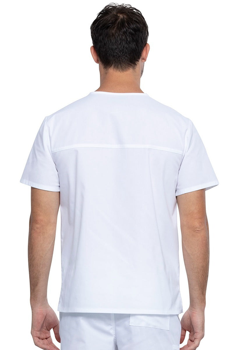 An image of a Male Medical Assistant wearing a Cherokee Unisex Tuckable V-neck Scrub Top in White size 3XL featuring a back yoke & dolman sleeves.