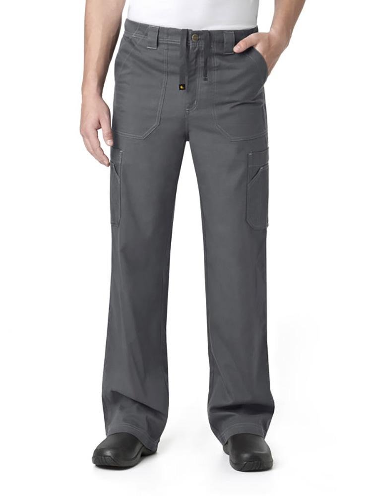 A male Pharmacy Tech wearing a Carhartt men's Multi-Pocket Cargo Scrub Pant  in pewter size extra large featuring a fully functional zipper fly.