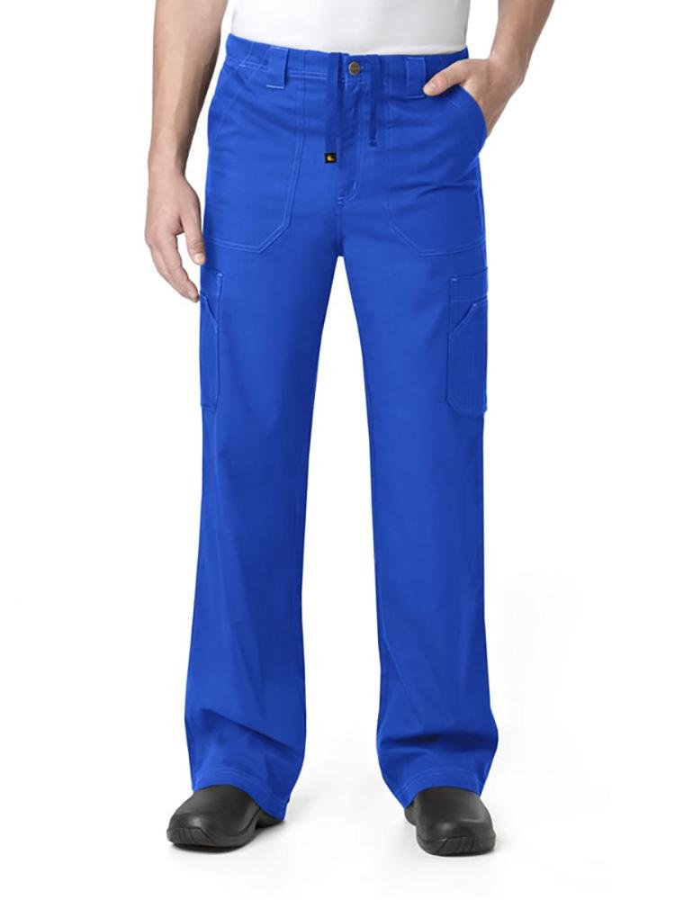 A male Pharmacist wearing a Carhartt men's Multi-Pocket Cargo Scrub Pant in royal size 2X featuring a total of 8 pockets.