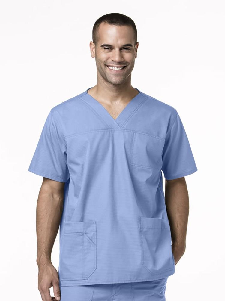 A male Phlebotomist wearing a Carhartt men's Ripstop Multi-Pocket Scrub Top in ceil size small featuring a total of 4 pockets.