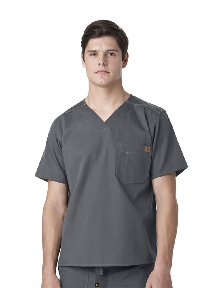 A male Medical Biller wearing a Carhartt men's Ripstop Utility Scrub Top in pewter size large featuring a tradesmen pocket on the wearer's left side chest.