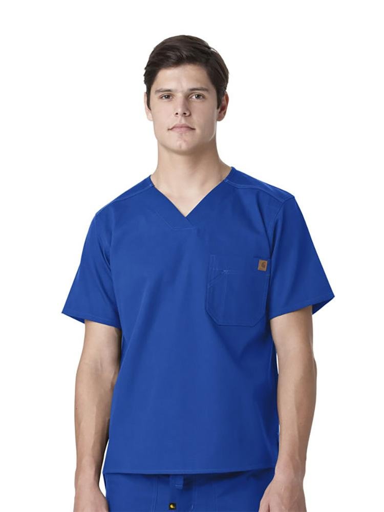 A Male Medical Secretary wearing a Carhartt men's Ripstop Utility Scrub Top in royal size extra large featuring a back pleat and a split hem for a full range of mobility for reaching.